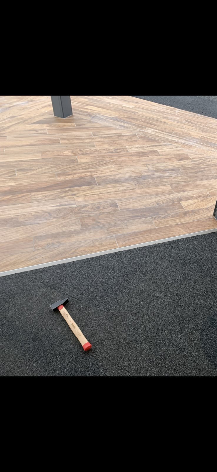 Pose de dalles de moquette au maillet dans un magasin des Deux-Sèvres